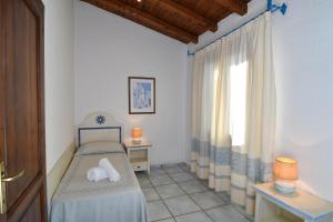 Postel nebo postele na pokoji v ubytování Li Suari Club Village
