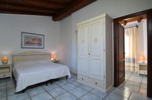 Postel nebo postele na pokoji v ubytování Li Suari Club Village