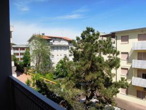 a tree on the balcony of a building at Condominio San Michele in Bibione