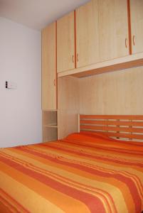 a bedroom with a large bed with wooden cabinets at Condominio San Michele in Bibione