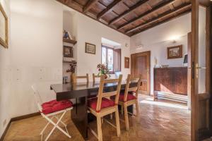 a dining room with a table and chairs at By the charming Piazza Navona - FromHometoRome in Rome