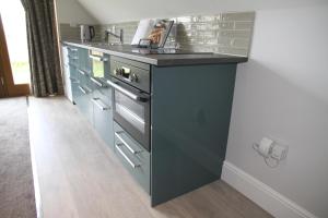 a kitchen with a sink and a counter top at Superb Stokesby Barn Apartment - Norfolk Broads & Norwich in Stokesby