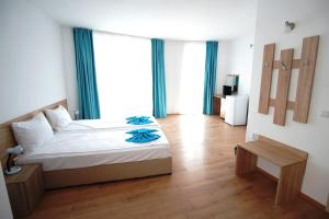 Postel nebo postele na pokoji v ubytování Hotel Elitza