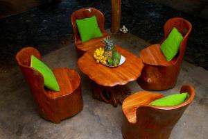 a table and chairs with a bowl of fruit on it at YalaWay Nature Villa in Tissamaharama