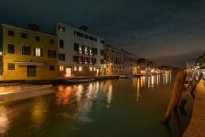 a view of a canal at night with buildings at Ca' Bonfadini Historic Experience in Venice