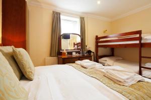 a bedroom with two bunk beds and a mirror at Burbage Holiday Lodge Apartment 2 in Blackpool