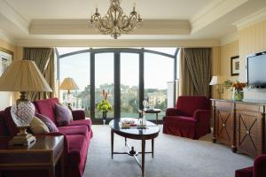 a living room filled with furniture and a large window at InterContinental - Kyiv, an IHG Hotel in Kyiv