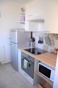 a kitchen with a white refrigerator and a sink at Razgled/The View in Koper