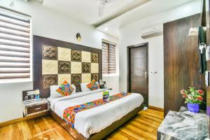 a bedroom with a large bed in a room at FabHotel Aman Residency Sharifpura in Amritsar +20 photos