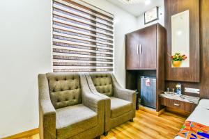a living room with a couch and a television at FabHotel Aman Residency Sharifpura in Amritsar