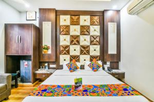 a bedroom with a bed and a wall with tiles at FabHotel Aman Residency Sharifpura in Amritsar