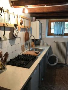 a kitchen with a stove and a counter top at Casadelsale in Lusiana