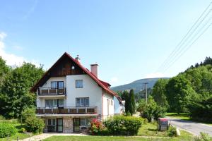 una gran casa blanca con techo rojo en Chalupa Slunečná, en Černý Důl