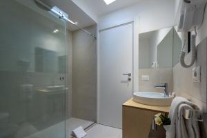 a bathroom with a sink and a glass shower at Vitop Residence in San Vito lo Capo