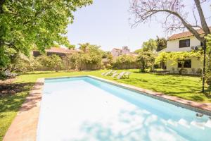 a swimming pool in the backyard of a house at Susana Just Boutique Hotel in Vicente López