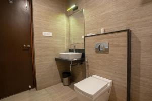 a bathroom with a toilet and a sink at The Livin-Bani Park in Jaipur +38 photos