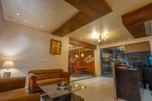 a living room with a couch and a table at The Livin-Bani Park in Jaipur