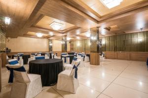 a banquet hall with a table and chairs in it at The Livin-Bani Park in Jaipur