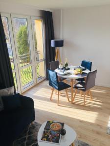 a living room with a table and chairs and a dining room at Apartament Bora Stronie Śląskie in Stronie Śląskie