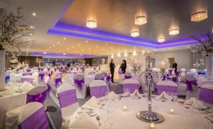 a banquet hall with white tables and purple chairs at Clayton Hotel & Leisure Club Sligo in Sligo +16 photos