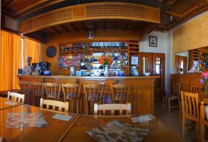 a bar in a restaurant with a table and chairs at Hotel Ionion in Kyllini