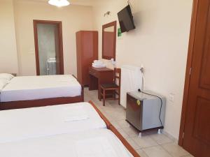 Ein Bett oder Betten in einem Zimmer der Unterkunft Hotel Ionion