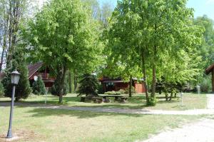a park with a bench and trees and a building at Center Angelos in Bronków