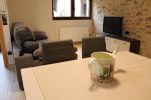 a living room with a table with a cup on it at Casa Rural Tarayuela in Cantavieja