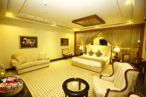 a hotel room with a bed and a couch at Bahria Grand Hotel & Resort in Lahore +54 photos