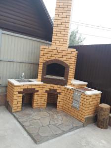 a brick oven with a sink in a patio at Дом у моря in Zatoka