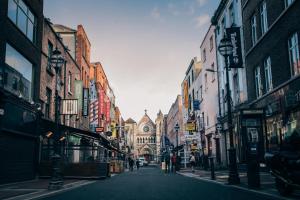 a city street with people walking down the street at Arlington Hotel O'Connell Bridge in Dublin