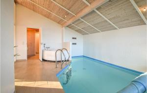 a swimming pool in a room with a bath tub at Awesome Home In Juelsminde With Kitchen in Sønderby
