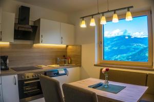 a kitchen with a table with a vase of flowers on it at Apart Sporer in Hippach