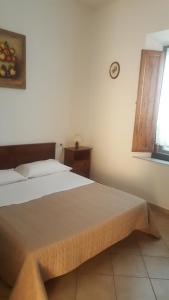 A bed or beds in a room at Casa di Alfredo Affittacamere