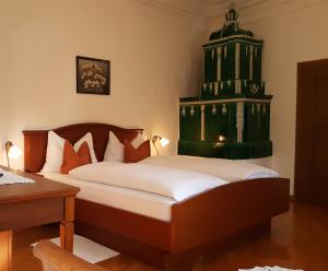 a bedroom with a bed with a green structure at Ansitz Strengherrnhof in Caldaro