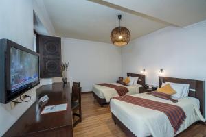 A bed or beds in a room at La Casona Hotel Boutique