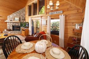 a dining room with a table and chairs in a cabin at Windsong in Sevierville