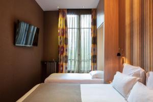 Кровать или кровати в номере Hôtel Regent's Garden - Astotel