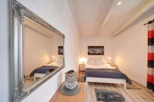 a bedroom with two beds and a large mirror at Apartamenty i Pokoje Karpacz - centrum Karpacza, parking w cenie! in Karpacz