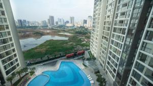 a view of a swimming pool between two tall buildings at LUXURY APARTMENT VINHOMES SKYLAKE 5min to KEANGNAM in Hanoi