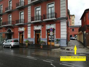 a building on a street with a car parked in front at Hotel Nuvò in Naples