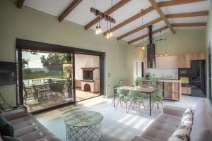 a living room with a couch and a table at Premium Ionian Villas - Vlachata in Vlachata