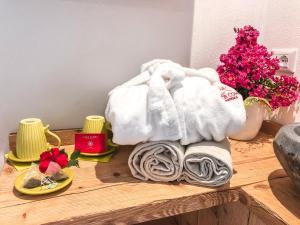 a table with towels and flowers on it at Residence Lake Como in Colico