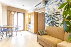 a living room with a couch and a table at Costa Rica Bibione Aparthotel in Bibione