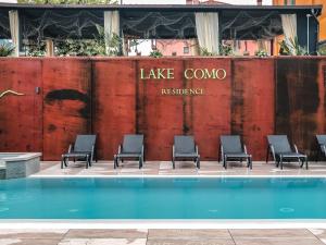 a group of chairs sitting next to a swimming pool at Residence Lake Como in Colico