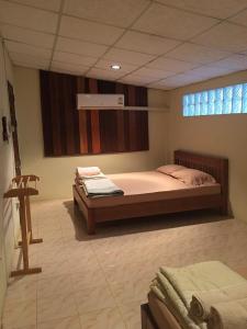 ein Schlafzimmer mit einem großen Bett und einem Fenster in der Unterkunft บ้านศรีสมบูรณ์ เชียงคาน in Chiang Khan