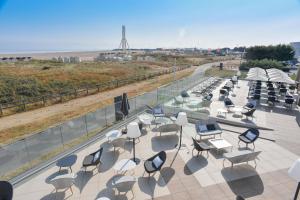 a group of chairs and tables on a roof at Thalazur Ouistreham - Hôtel & Spa in Ouistreham