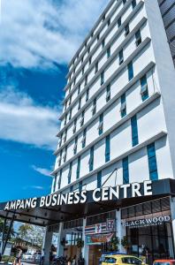 a tall building with an amazing business centre sign on it at Urban Inn, Alor Setar in Alor Setar