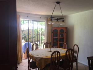 a dining room with a table and chairs and a window at habitaciones exclusivas in Curicó