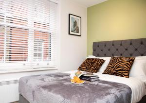 a bedroom with a bed with a tray of books on it at Carnaby Studios by Indigo Flats in London